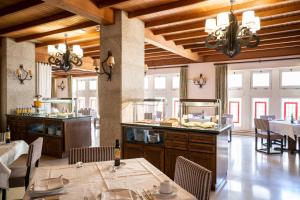 a restaurant with tables and chairs and a buffet at Parador de Vilalba in Villalba