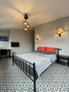 a bedroom with a bed with red pillows and a ceiling at Beyoğlu Huzur Apart in Istanbul