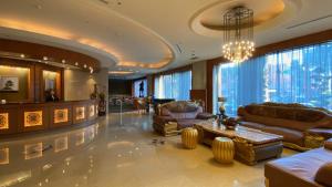 a large living room with couches and a chandelier at Monarch Plaza Hotel in Taoyuan