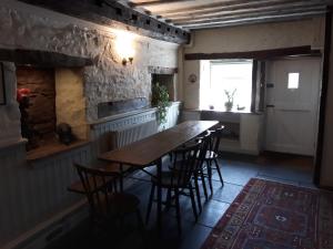 a dining room with a table and chairs and a fireplace at 6 Bridge St. in Brecon