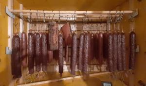 a row of meat hanging on a rack at Gasthof Prinz 