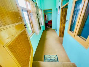 a hallway of a house with a door and a staircase at Grand view lodge and Restaurant Dharamshala - Partial Prepayment required to confirm booking in Dharamshala