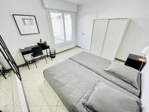 um quarto com uma cama, uma mesa e cadeiras em Flatshare Colocation 1 close to Geneva em Saint-Genis-Pouilly