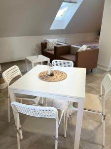 a white dining table and chairs in a living room at Ubytování pod Troskami in Rovensko pod Troskami