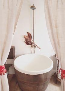 a bath tub in a bathroom with curtains at Roselina in Hastings