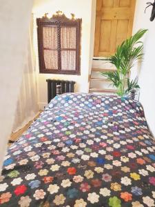 a bed with a colorful quilt on it in a room at Roselina in Hastings