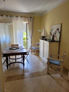 a living room with a table and a chair at Appartamento Stella Marina a due passi dal mare e dal centro in Marina di Carrara