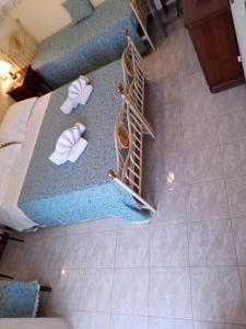 an overhead view of a bedroom with a bed and towels at B&B Le Begonie in Ascoli Piceno