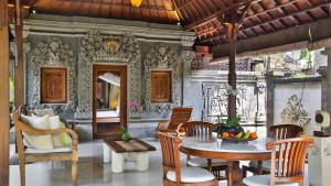 a dining room with a table and chairs at The Citta Luxury Residence in Seminyak