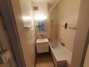 a bathroom with a sink and a tub and a toilet at Sonnegg Guest Rooms Inh M Bisegger in Zurich