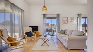 a living room with a couch and two chairs at Villa Calima by Calima Villas in Costa de Antigua