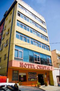 a hotel building with a hotel sign on it at Hotel Cristal Madagascar in Antananarivo