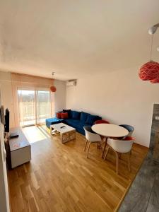 ポドゴリツァにあるZ apartmentの青いソファとテーブルのあるリビングルーム