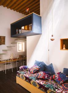 a living room with a bed and a dining room at Casa.b Mogador in Essaouira