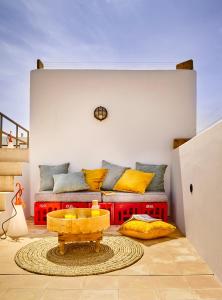 a living room with a couch and a table at Casa.b Mogador in Essaouira