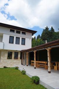 a large white house with a large patio at Вила Релакс in Smolyan