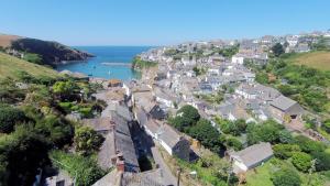 an aerial view of a small town on the coast at Pibbies in Port Isaac