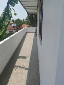 a shadow of a person on the side of a building at Juliya Guest House in Negombo