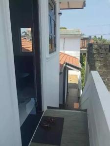 an open door of a house with a balcony at Juliya Guest House in Negombo