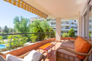 a balcony with furniture and a view of a building at Letmalaga Campos de Guadalmina in Marbella