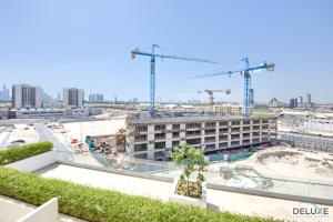 una vista de un edificio en construcción con grúas en Homely Studio in Azizi Aliyah Residence Al Jadaf by Deluxe Holiday Homes, en Dubái