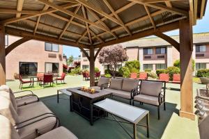 an outdoor patio with chairs and tables and a pavilion at Ramada by Wyndham Arcata in Arcata