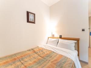 Postel nebo postele na pokoji v ubytování Tabist Hotel Mercury Asakusabashi