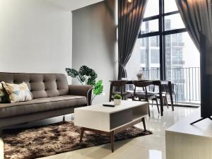 a living room with a couch and a table at Ekocheras Suite in Kuala Lumpur