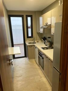 a small kitchen with a sink and a stove at Picasso - Luxury apartment with swimming pool in Casablanca