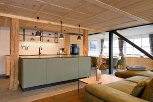 an open kitchen and living room in a house at Hoheneck Apartment in Mittelberg