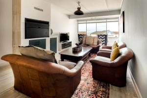 a living room with two couches and a tv at NORDSTRANDPARK 26 Main Beach Area in Swakopmund