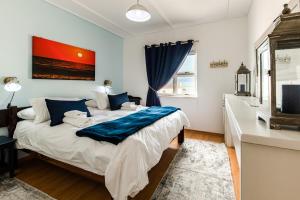 a bedroom with a bed with a blue blanket on it at NORDSTRANDPARK 26 in Swakopmund