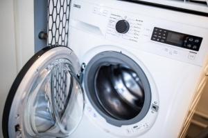 a washer and dryer in a room at Tremendous 2-Bedroom Serviced Apartment - 79 m2 in Rotterdam