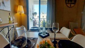 einen Tisch mit Weingläsern und einen Teller mit Essen in der Unterkunft Paramount Gardens Resorts C202 in Larnaka