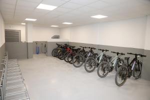 a row of bikes are lined up against a wall at VÍA XIX in Caldas de Reis