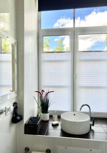 a bathroom with a sink and a large window at Vabriku 6 Apartment with sauna in Rakvere