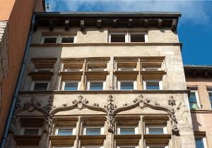 a tall building with windows on the side of it at La Maison Debourg in Lyon