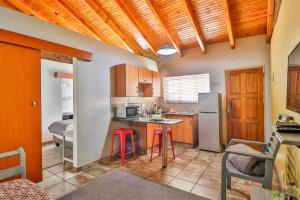 a kitchen with a counter and a sink and a refrigerator at Rudman Townhouses Self-catering Accommodation in Boksburg