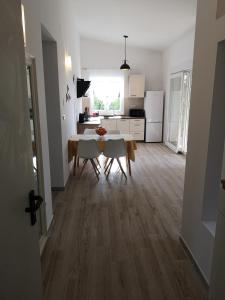 a kitchen and dining room with a table and chairs at Apartment Nada 2 in Malinska