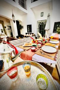 a long table with plates and bowls of food on it at Riad El Jadide in Marrakesh