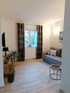 a living room with a couch and a table at Apartment Nada 2 in Malinska