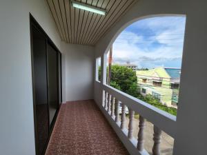 a hallway with a large window and a staircase at HOMMORY RESIDENCE - Chalong West in Ban Klang