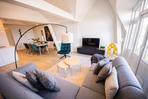 un soggiorno con divano e tavolo di Grandly 3 Bedroom Serviced Apartment 83m2 -NB306G- a Rotterdam