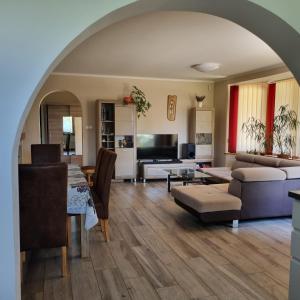 a living room with a couch and a table at Holiday Vendégház in Siófok