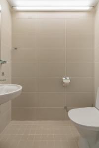 a bathroom with a toilet and a sink at Raadimõisa Hotell in Tartu