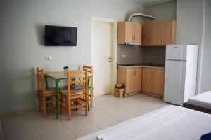 a kitchen with a table and chairs and a refrigerator at Villa Kristina in Himare