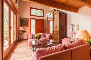 ein Wohnzimmer mit rosa Sofas und einem Tisch in der Unterkunft Casa en Montseny con piscina in Sant Pere de Vilamajor