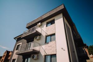 a building with balconies on the side of it at Dream House Apartments in Oradea