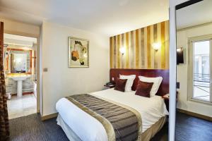 Postel nebo postele na pokoji v ubytování Hotel Opéra d'Antin
