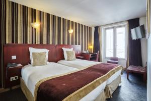 Postel nebo postele na pokoji v ubytování Hotel Opéra d'Antin